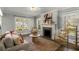 Bright and inviting living room featuring a fireplace, neutral decor, and large windows at 2217 Virginia Ne Pl, Atlanta, GA 30305