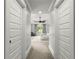 Bright bedroom view down hallway, featuring tray ceiling, ceiling fan, and window with curtains at 2217 Virginia Ne Pl, Atlanta, GA 30305