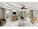 Spacious main bedroom featuring a tray ceiling, ceiling fan, many windows, and neutral décor at 2217 Virginia Ne Pl, Atlanta, GA 30305