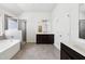 Bathroom featuring a tub, shower, dark vanity, double sink, and tile flooring at 2450 Overlook Ave, Lithonia, GA 30058