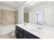 Modern bathroom boasts a double vanity, tiled shower, and neutral finishes at 2450 Overlook Ave, Lithonia, GA 30058