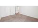 Spacious bedroom featuring carpeted floors, white walls, and a double door closet at 2450 Overlook Ave, Lithonia, GA 30058