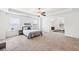 Spacious bedroom featuring a large bed, tray ceiling, and neutral decor with a work out area at 2450 Overlook Ave, Lithonia, GA 30058
