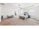 Spacious bedroom featuring a large bed, tray ceiling, and neutral decor at 2450 Overlook Ave, Lithonia, GA 30058