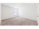 Bedroom with carpet flooring, a window, and a door at 2450 Overlook Ave, Lithonia, GA 30058