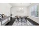 Dining room features modern table, chairs, neutral rug, and hardwood flooring, perfect for entertaining at 2450 Overlook Ave, Lithonia, GA 30058