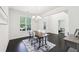 Spacious dining room with dark wood floors, modern furnishings, and large windows offering a bright, airy feel at 2450 Overlook Ave, Lithonia, GA 30058