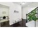 Elegant foyer area featuring wood floors, a staircase, and stylish decor at 2450 Overlook Ave, Lithonia, GA 30058