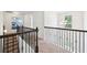 Upstairs hallway with dark railings at 2450 Overlook Ave, Lithonia, GA 30058