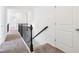 Hallway with carpeted floors, white doors, and elegant wrought iron railings at 2450 Overlook Ave, Lithonia, GA 30058