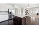 Modern kitchen with granite island, stainless steel refrigerator, white cabinets, and hardwood floors at 2450 Overlook Ave, Lithonia, GA 30058