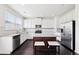 Modern kitchen features white cabinets, stainless steel appliances, and a center island, offering a stylish cooking space at 2450 Overlook Ave, Lithonia, GA 30058