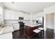 Bright kitchen with white cabinetry, stainless steel appliances, and a center island, perfect for meal preparation and gatherings at 2450 Overlook Ave, Lithonia, GA 30058