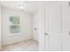Laundry room with tile flooring, window and door at 2450 Overlook Ave, Lithonia, GA 30058