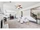 Bright, open-concept living room flows into a modern kitchen and features stylish furnishings and a cozy fireplace at 2450 Overlook Ave, Lithonia, GA 30058