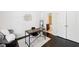 Bright office features a modern desk and chair, decorative accents, and a view of the bathroom at 2450 Overlook Ave, Lithonia, GA 30058
