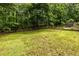 Large backyard, bordered with mature trees and wooden fence at 1130 Timbercreek Ct, Alpharetta, GA 30005