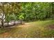 The backyard features a wooden deck with lush trees and a fence at 1130 Timbercreek Ct, Alpharetta, GA 30005