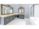 A spacious bathroom with gray cabinets, a double sink vanity, white tile floors, a tub, and a shower at 1130 Timbercreek Ct, Alpharetta, GA 30005