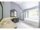 Spacious bathroom features double sinks, a soaking tub, a walk-in shower, and plenty of natural light at 1130 Timbercreek Ct, Alpharetta, GA 30005