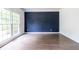 Bedroom featuring hardwood floors, and a large window that provides ample natural light at 1130 Timbercreek Ct, Alpharetta, GA 30005