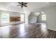 Spacious bedroom with tray ceilings, two windows, ceiling fan, and wood accent wall at 1130 Timbercreek Ct, Alpharetta, GA 30005