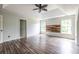 Light-filled bedroom with modern wood accent wall, two windows, wood-look floors and a ceiling fan at 1130 Timbercreek Ct, Alpharetta, GA 30005