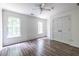 This bedroom features wood floors, two windows and a ceiling fan at 1130 Timbercreek Ct, Alpharetta, GA 30005