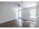 Light and bright bedroom with shiplap accent wall, wood-look floors, and a ceiling fan at 1130 Timbercreek Ct, Alpharetta, GA 30005