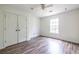 Bedroom with wood floors, ceiling fan, and spacious double-door closet at 1130 Timbercreek Ct, Alpharetta, GA 30005