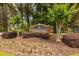 Stone Windhaven community entrance sign surrounded by lush landscaping and small flowering trees at 1130 Timbercreek Ct, Alpharetta, GA 30005