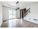 Formal dining area with hardwood floors, large windows, modern lighting, and entry to front foyer at 1130 Timbercreek Ct, Alpharetta, GA 30005