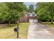 Charming two-story brick home featuring an attached two-car garage and a well-manicured front yard at 1130 Timbercreek Ct, Alpharetta, GA 30005