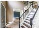 Foyer featuring hardwood floors, black and white stairs, and entry to living room at 1130 Timbercreek Ct, Alpharetta, GA 30005