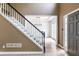 Foyer featuring hardwood floors, black and white stairs, and entryway to dining room at 1130 Timbercreek Ct, Alpharetta, GA 30005