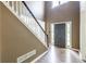 Foyer featuring hardwood floors, black and white stairs, and an entryway with sidelight windows at 1130 Timbercreek Ct, Alpharetta, GA 30005
