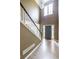 Front foyer features hardwood floors, staircase with black handrail, and sidelight windows at entry at 1130 Timbercreek Ct, Alpharetta, GA 30005