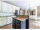 Bright kitchen with white cabinets, granite counters, stainless refrigerator, and center island at 1130 Timbercreek Ct, Alpharetta, GA 30005