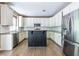 Spacious kitchen featuring white cabinets, stainless steel appliances, granite countertops, and a center island at 1130 Timbercreek Ct, Alpharetta, GA 30005