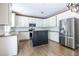 Spacious kitchen featuring white cabinets, stainless steel appliances, granite countertops, and a center island at 1130 Timbercreek Ct, Alpharetta, GA 30005