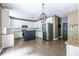 Spacious kitchen featuring white cabinets, stainless steel appliances, and a center island at 1130 Timbercreek Ct, Alpharetta, GA 30005