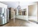 Spacious kitchen featuring stainless steel refrigerator and open view to the breakfast area at 1130 Timbercreek Ct, Alpharetta, GA 30005
