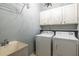 Laundry room featuring a wash basin, washer, and dryer at 1130 Timbercreek Ct, Alpharetta, GA 30005