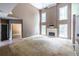 Bright living room with high ceilings, a fireplace, and large windows providing natural light at 1130 Timbercreek Ct, Alpharetta, GA 30005