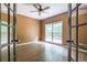 Home office with hardwood floors, window, and glass french doors at 1130 Timbercreek Ct, Alpharetta, GA 30005