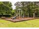 Community playground featuring a slide, swings, climbing structures, and a bench surrounded by grass at 1130 Timbercreek Ct, Alpharetta, GA 30005