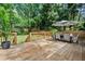 Spacious deck with a dining set, perfect for enjoying the serene, tree-lined backyard at 2238 Pinecliff Ne Dr, Atlanta, GA 30345