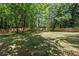 Large, grassy backyard surrounded by trees and a wooden fence, providing privacy and a natural setting at 2238 Pinecliff Ne Dr, Atlanta, GA 30345