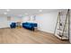 Finished basement area with blue velvet furniture, modern flooring, and built-in shelving at 2238 Pinecliff Ne Dr, Atlanta, GA 30345