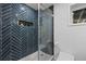 Contemporary bathroom featuring blue tiled shower with glass door and built-in shelves at 2238 Pinecliff Ne Dr, Atlanta, GA 30345